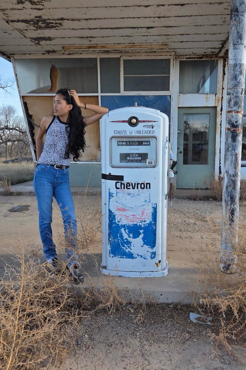 Woman at vintage gas pump